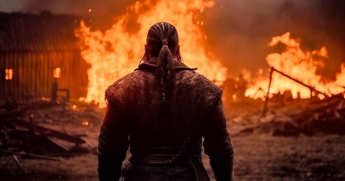 Viking raider surveys his work at a burning medieval village.	Source: ParinApril/Adobe Stock
