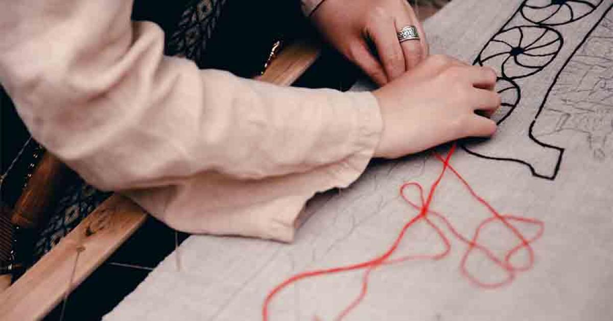A Scandinavian woman working on a embroidery pattern modern times, which must have been quite similar to Viking embroidery in the Viking Age. 
