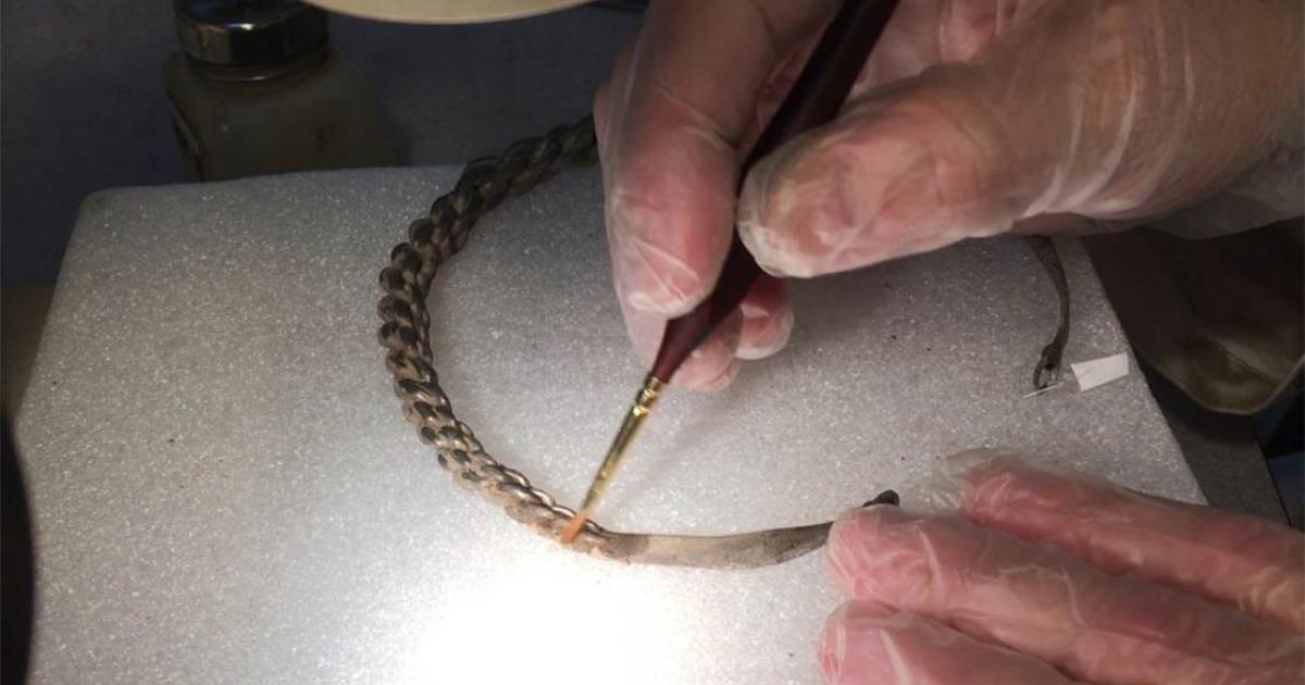 A piece of the Viking silver treasure hoardbeing cleaned by a conservator.      Source: Acta Konserveringscentrum AB