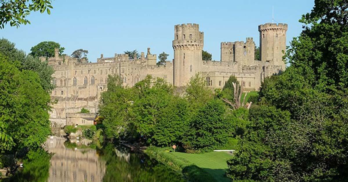 Warwick Castle from the bridge over the River Avon, Warwick, Warwickshire, UK.