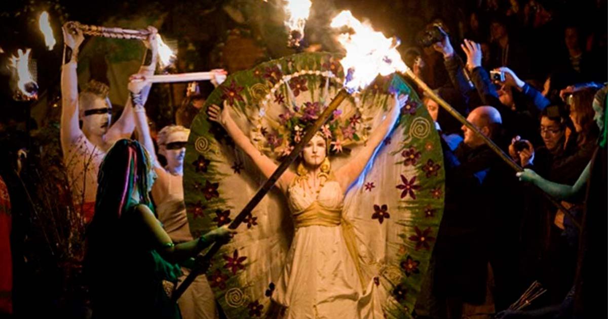 Lady parading with followers bearing torches, at the ancient Celtic festival of Beltane, marking the beginning of summer.	Source: chrisdonia/CC BY NC SA 2.0