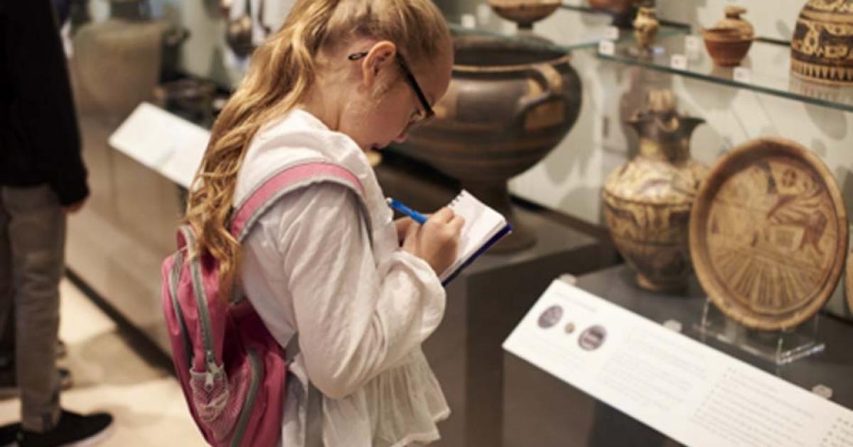 Student studying artifacts in a museum. Credit: Monkey Business / Adobe Stock