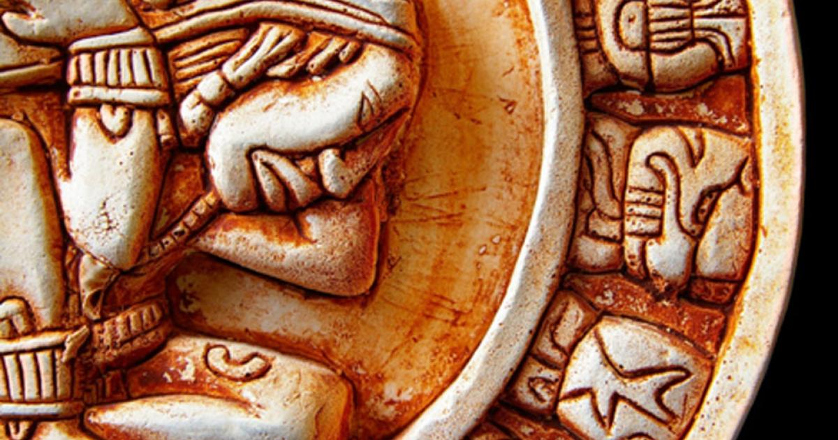 Closeup of glyphs on a Mayan calendar. Credit: zimmytws / Adobe Stock