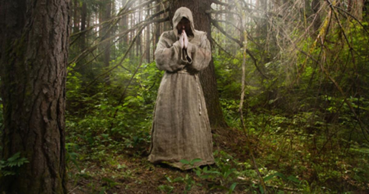 Monk in the forest Credit: Demian / Adobe Stock