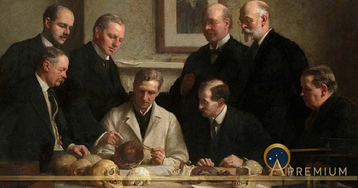 Group portrait of the Piltdown skull being examined by John Cooke in 1915. Back row: (left to right) F. O. Barlow, G. Elliot Smith, Charles Dawson, Arthur Smith Woodward. Front row: A. S. Underwood, Arthur Keith, W. P. Pycraft, and Sir Ray Lankester. Note the painting of Charles Darwin on the wall. (Public Domain).