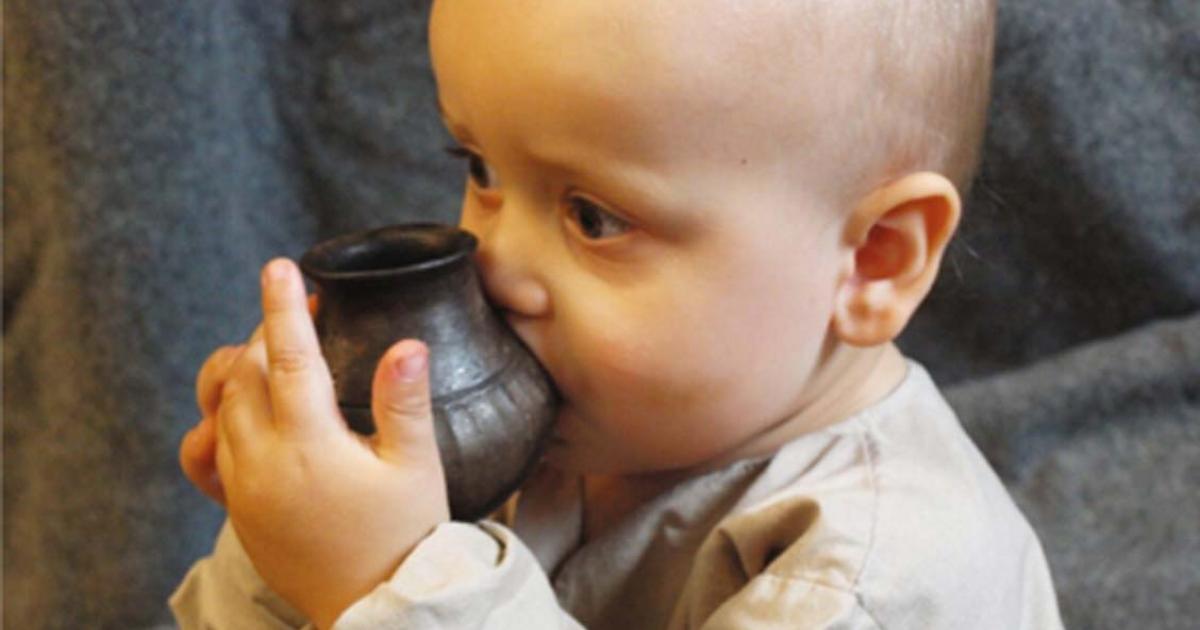 Infant drinking from a replica feeding vessel similar to the type investigated in the new study. Source: Helena Seidl da Fonseca, University of Vienna