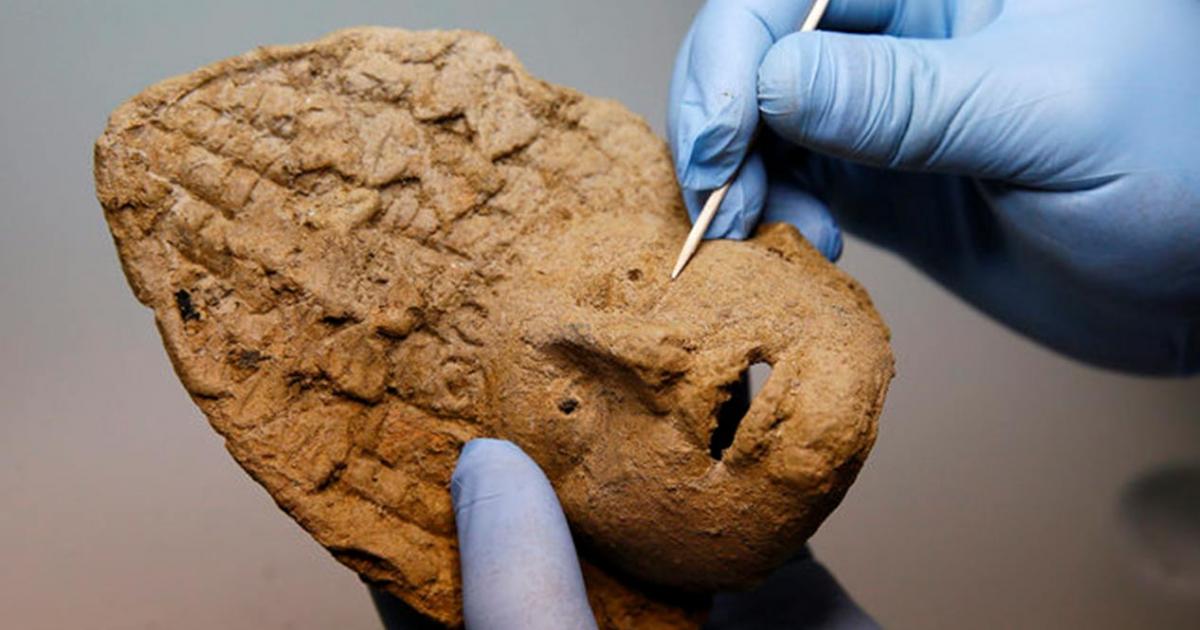 A baked clay theater mask that was discovered among the grave goods provides information about the people whose bodies were buried in the chamber. 