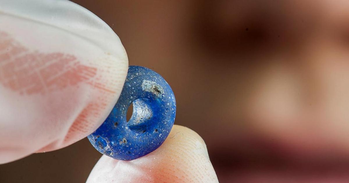 A blue glass bead at least 1,500 years old is among the finds archaeologists have made at the Ørland Main Air Station dig. 