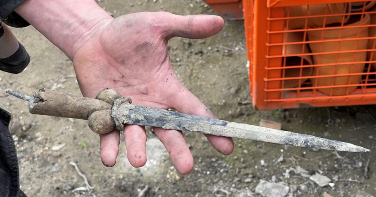 A researcher holding the bollock dagger that was found at Ypres, Belgium.	Source: VRT