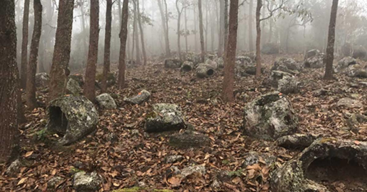 Group 1, burial jars shrouded in mist at Site 52. Source: Australian National University / Fair Use.