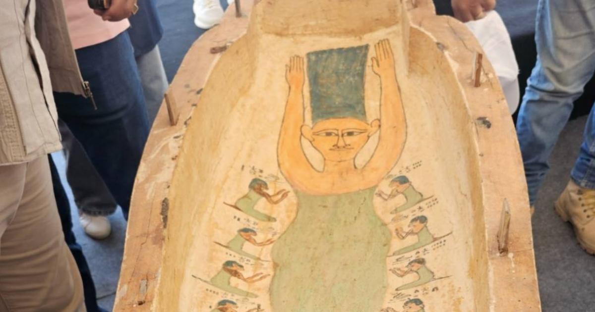 A carved and painted wooden coffin