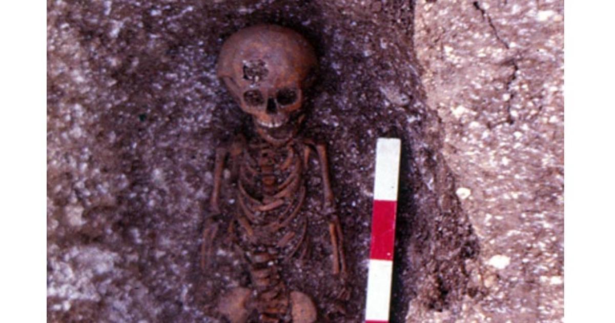 Featured image: A child burial at the abandoned medieval village of Hatch, which was excavated in the winter of 1984 and 1985. 