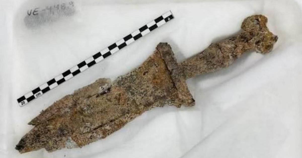 The first century BC dagger, rusted but still intact, that was removed from the back and burial of the second or third century Roman soldier.