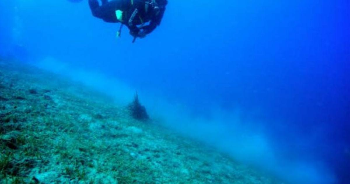 A diver works another ancient shipwreck off the coast of Italy, in 2012