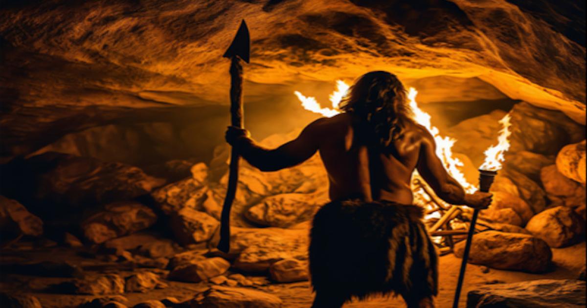 Early human trying to keep warm in a cave.