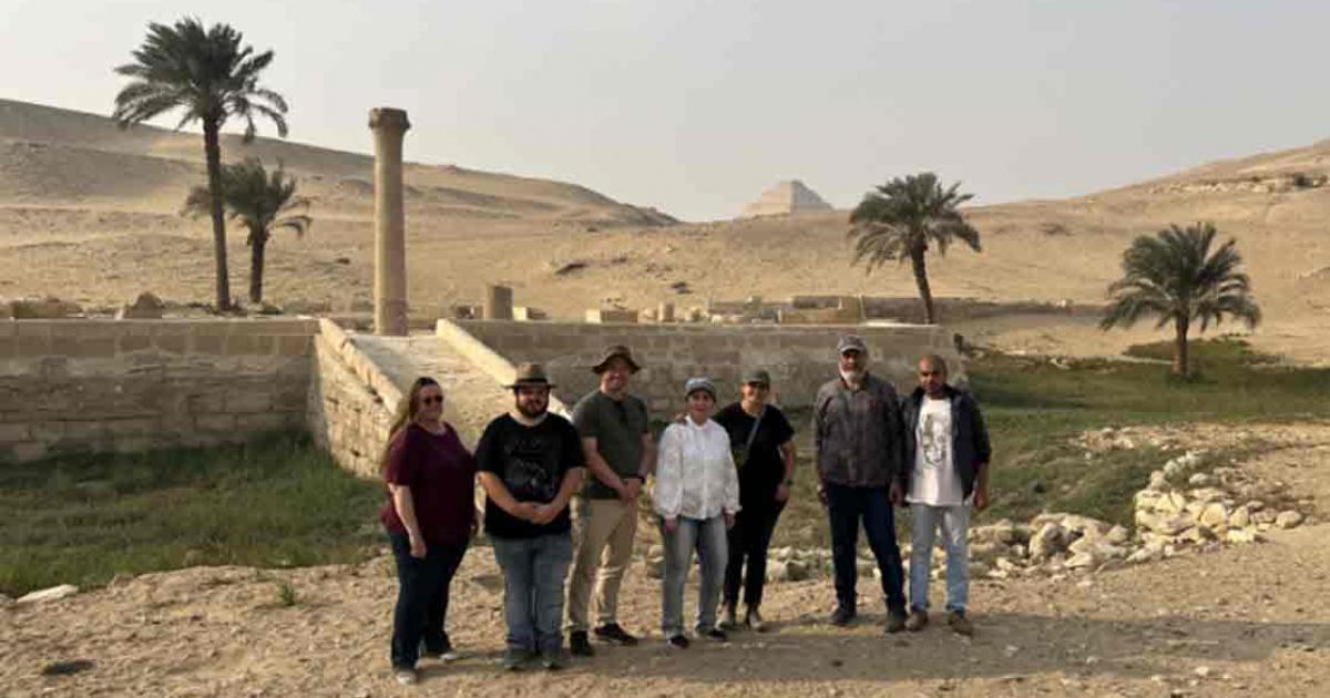 The research team stands in front of the pyramid of Unas’s Valley Temple, which acted as a river harbor in antiquity. Source: Eman Ghoneim/Nature