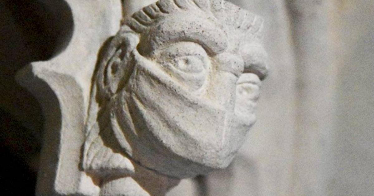 A figure wearing a face mask in St Albans Cathedral