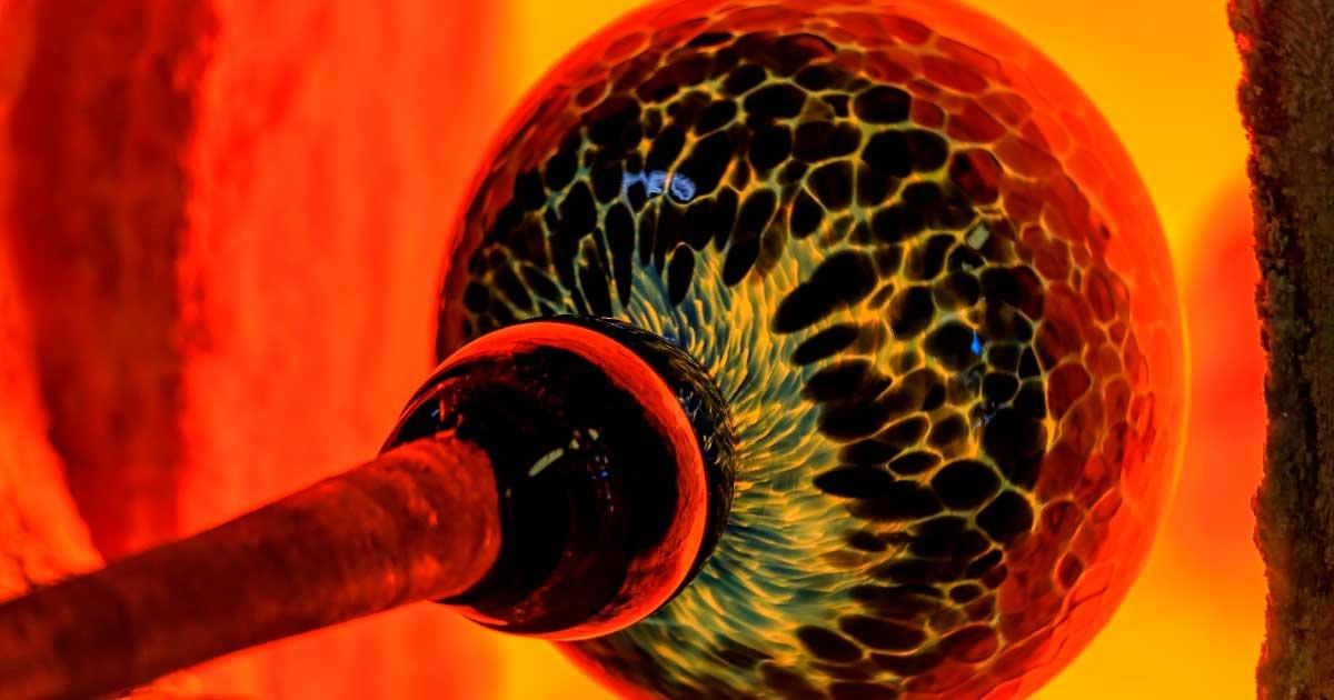 Glassblowing processs, with a ball of glass being heated by a kiln. Source: SvetlanaSF / Adobe Stock