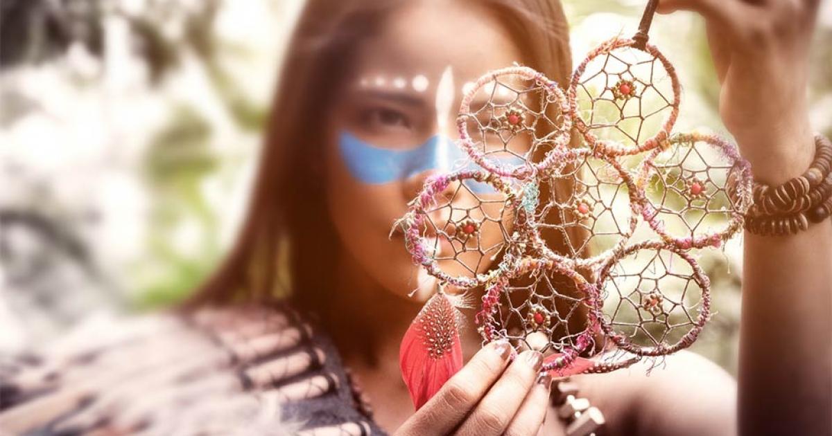 A Native American woman inspects an item for trade. Credit: montira / Adobe Stock