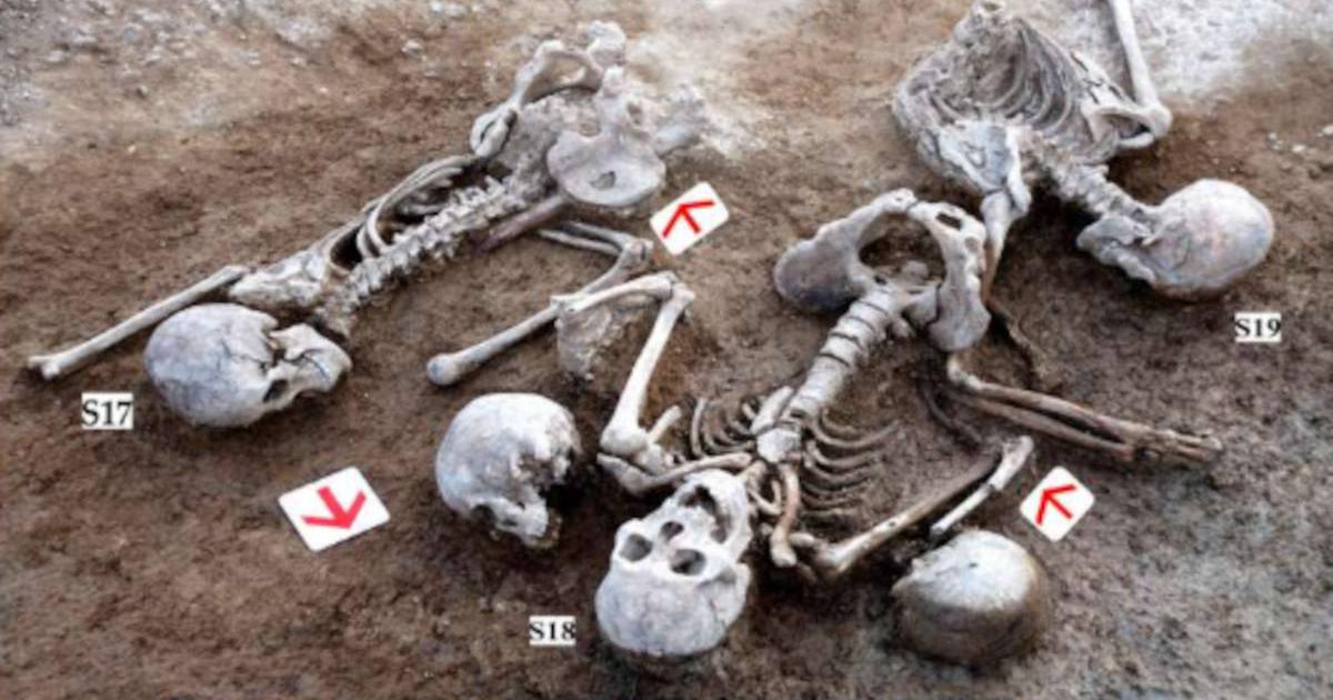 Battered skeletons plus extra unattached skulls excavated from site near Great Wall of China in 2009.