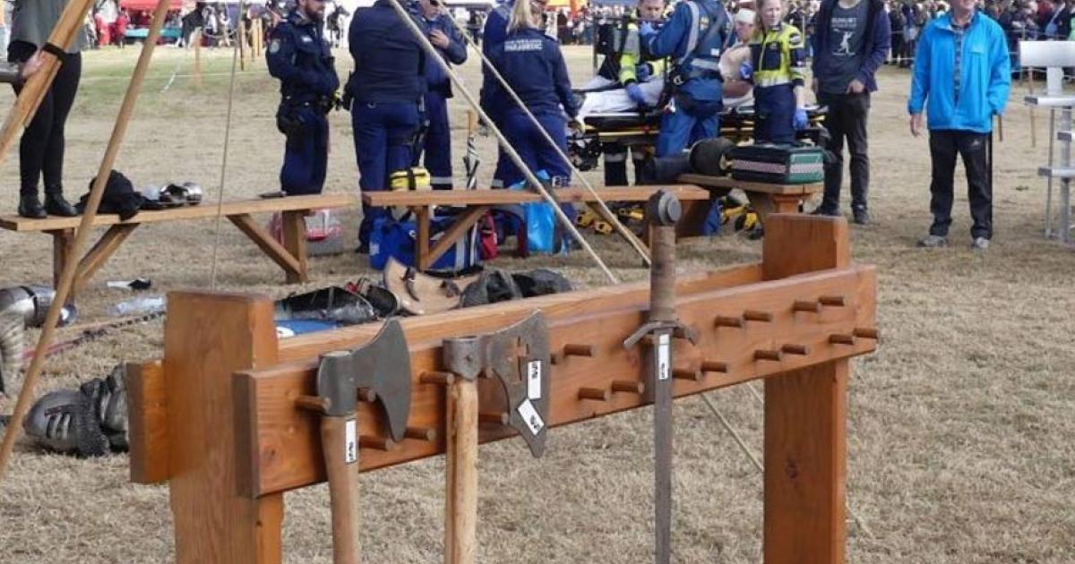Paramedics aid man at Hawkesbury Showground in New South Wales after he was struck in the head with a Medieval axe