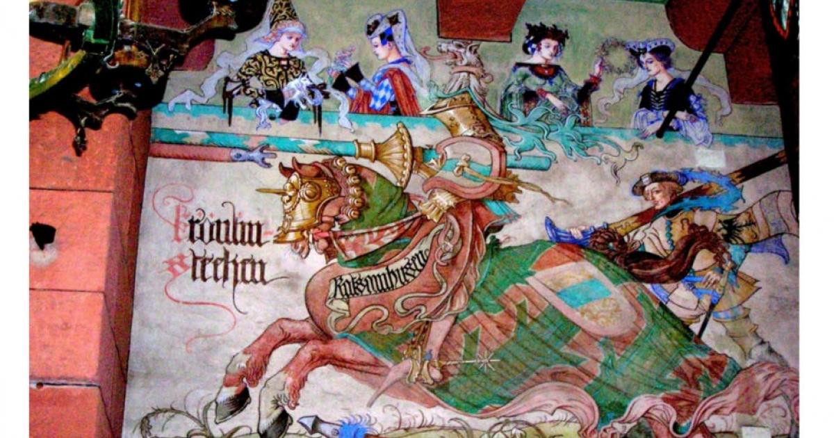 A neo-Gothic mural by Léo Scnug in a French castle depicting a medieval knight about to joust and four women in the audience, painted in the 1910s.