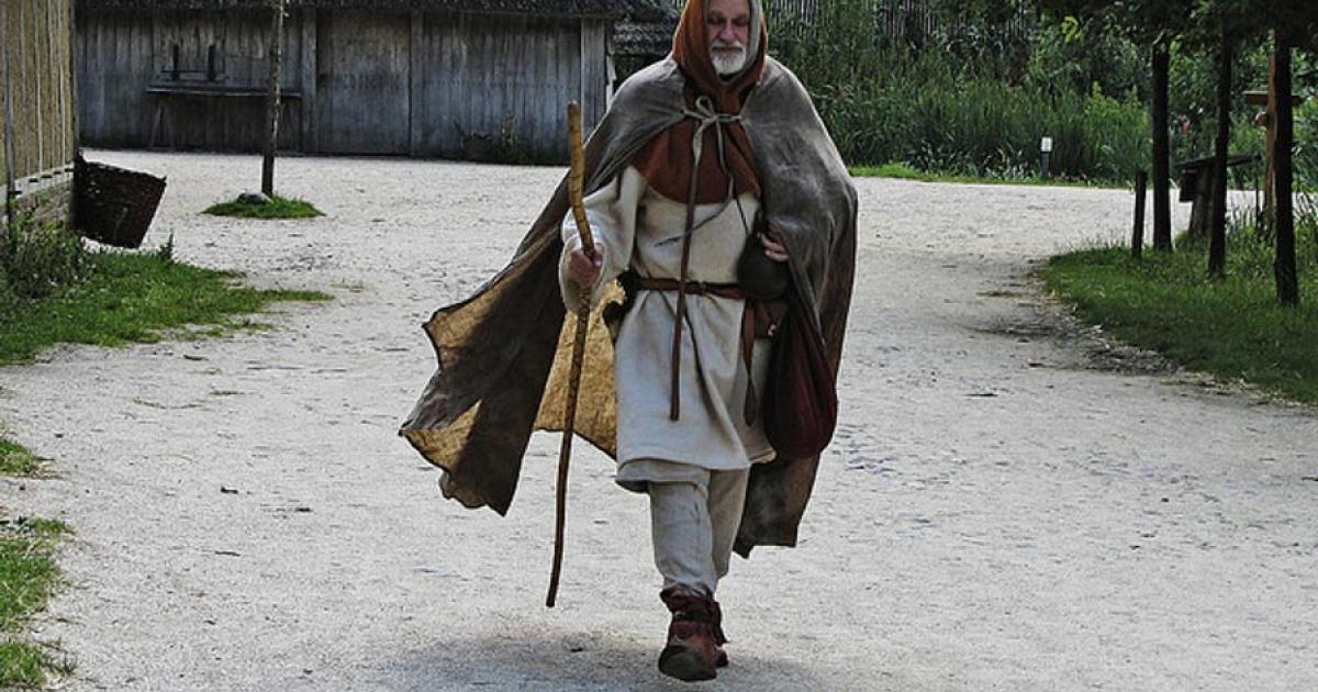 A reenactor dresses as a medieval pilgrim. 
