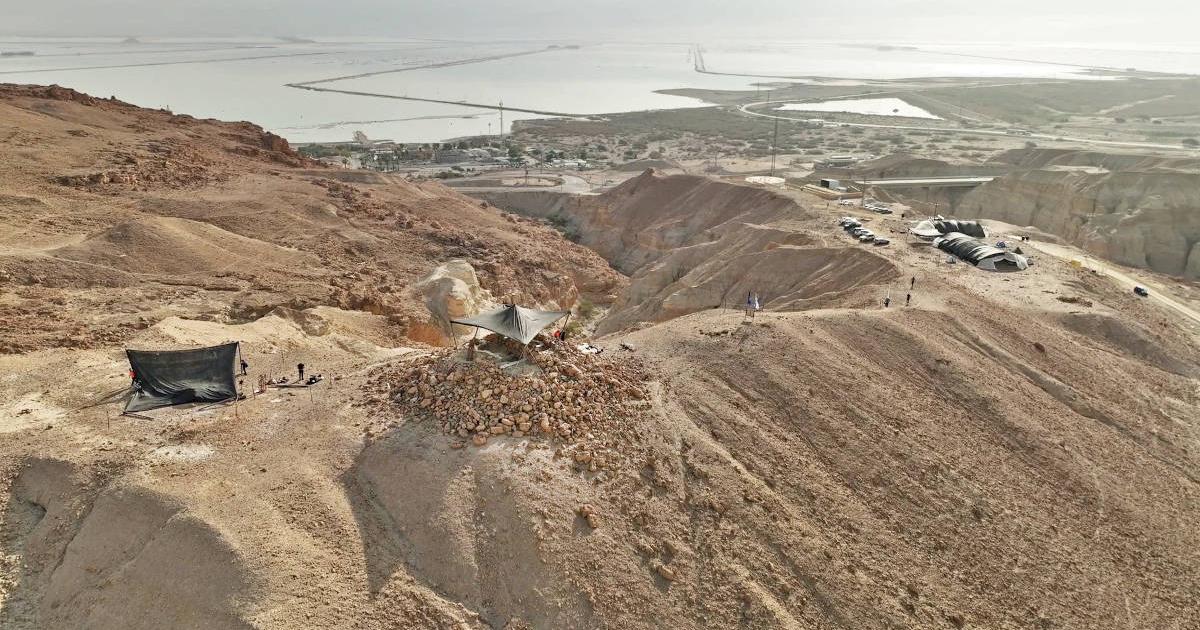 Broad view of excavation site in Nahal Zohar valley, with excavation site on upper section of pyramidal structure visible in the center.
