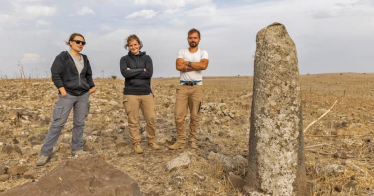 Archaeologists at a re-erected Roman milestone on the Golan Heights Roman highway.