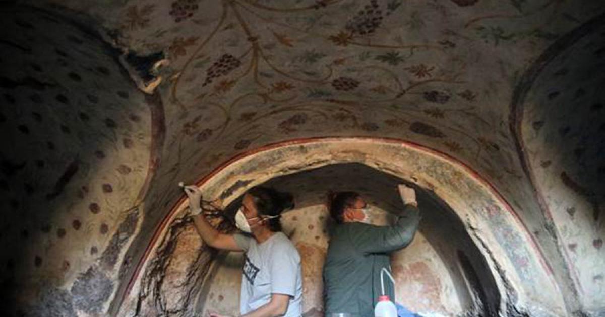 Archaeologists clean the motifs on the walls of a tomb found in the ancient city of Blaundus, Turkey.	Source: Anadolu Agency