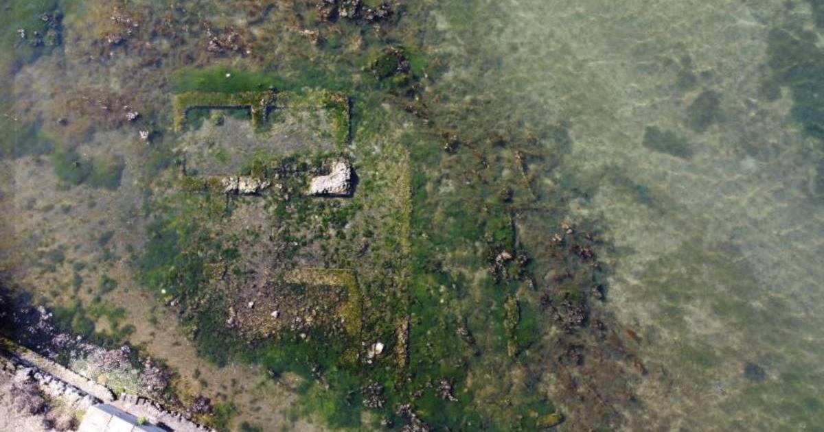 Aerial view of Lake Fusaro and the ruins of the Roman villa visible at the surface.