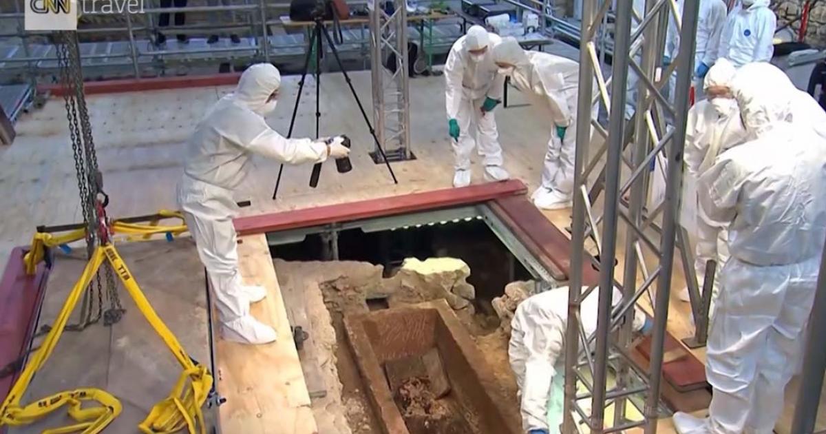 Scientists examining the inside of a 1,000-year-old sarcophagus in Mainz, Germany, after lifting the lid. Source: Print screen, CNN video.