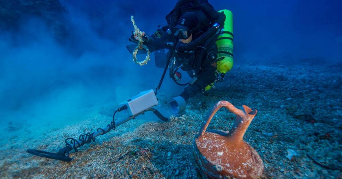 Metal detector survey of the shipwreck area, photo by Brett Seymour. 