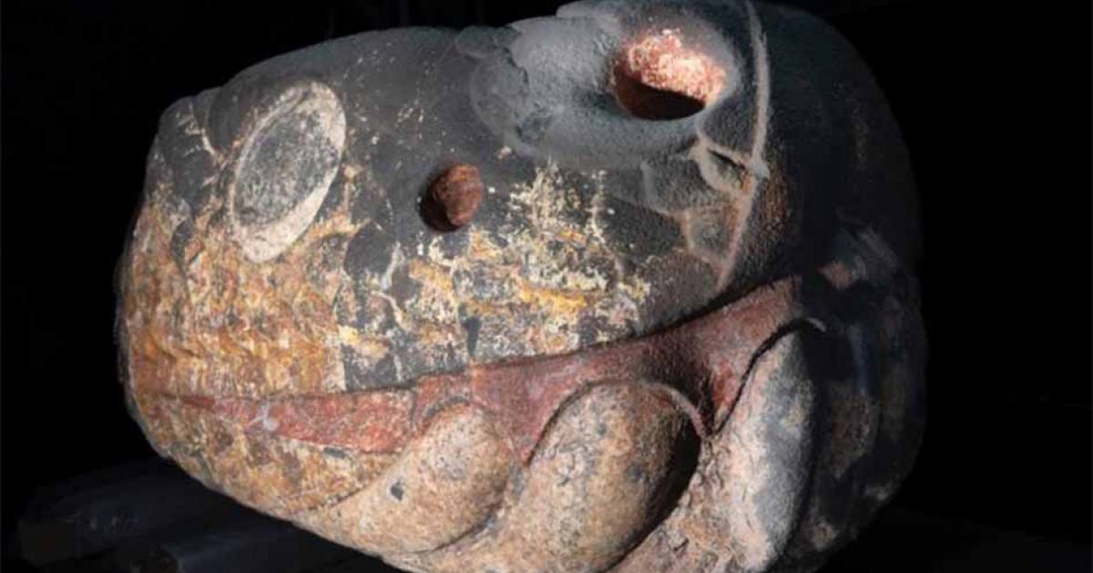 Colorful, stone snake deity head recovered in Mexico City.      Source: LANCIC. UNAM/INAH