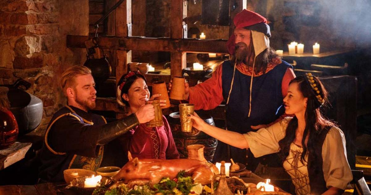 Israeli archaeologists working at the Tel Tsaf site in the Jordan valley have discovered the earliest evidence of social drinking in the Middle East, dating to 5000 BC. This image shows medieval people eating and drinking together in an ancient kitchen interior. 		Source: Nejron Photo / Adobe Stock