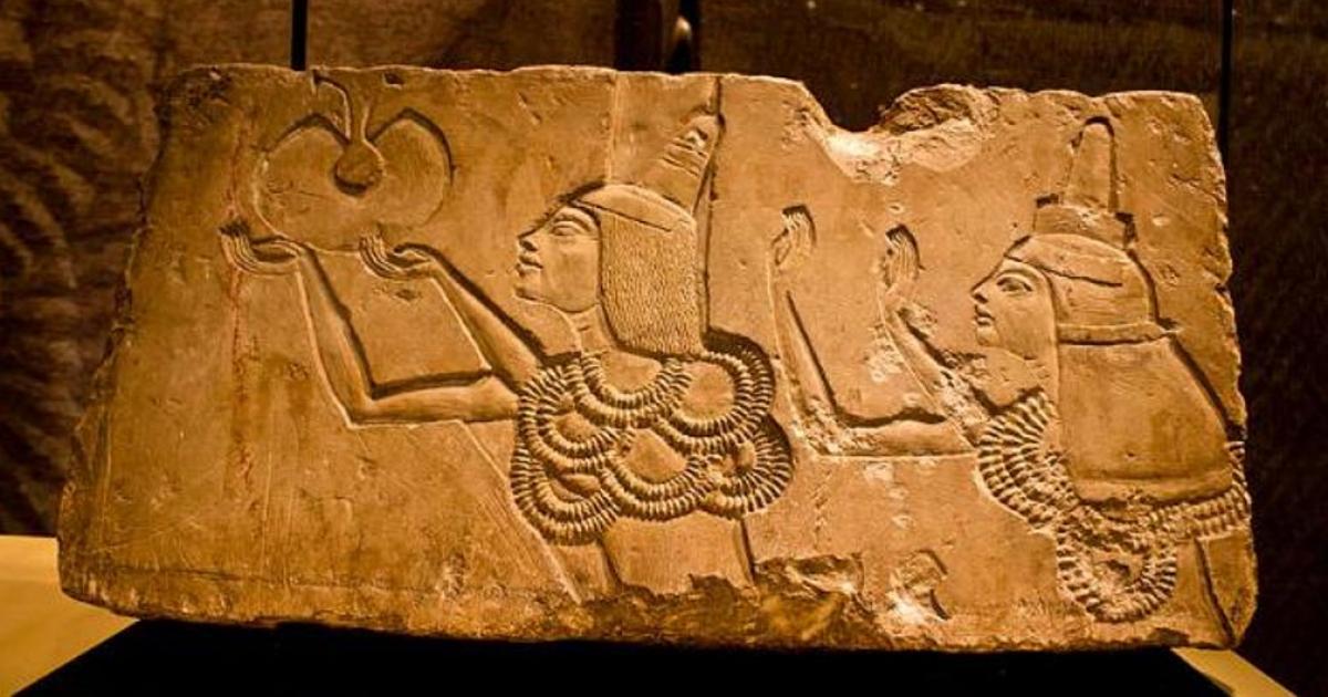 A stone block shows Ay receiving the 'Gold of Honor' award in his Amarna tomb from Akhenaten.