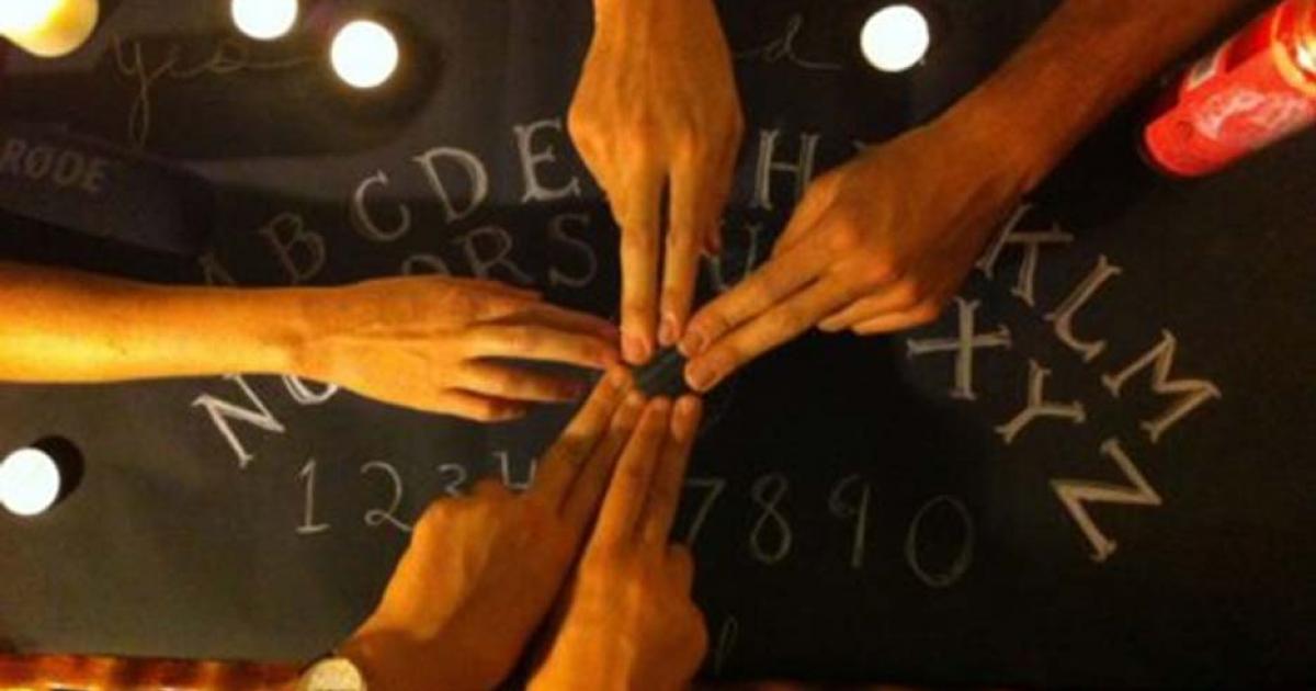People using a Ouija board