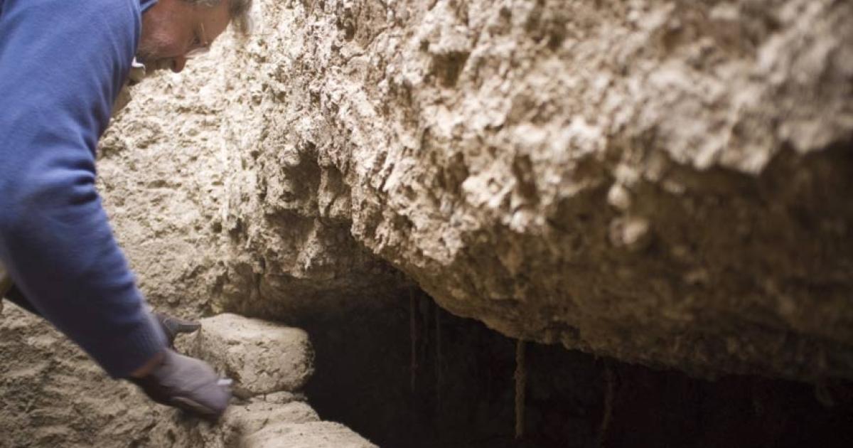 Professor Stuart Tyson Smith opens an intact tomb with the coffined, mummified burial of an elderly woman inside. 