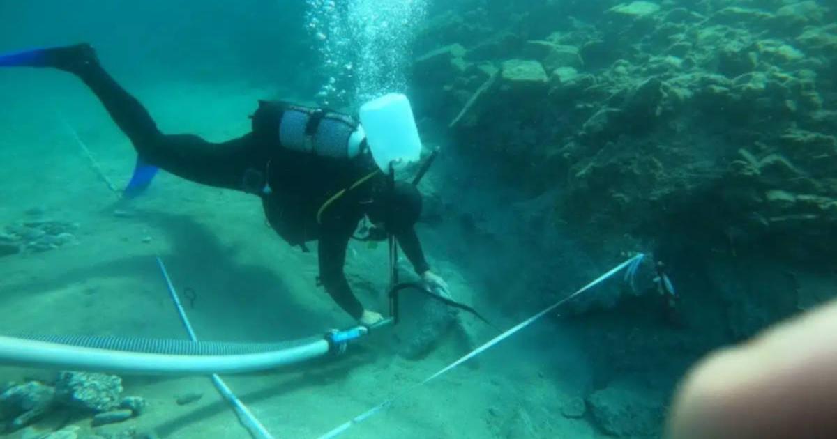 Underwater excavations occurring at site of port facilities submerged at site of ancient city of Asine.