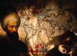 An illustration of a man in a turban, representing Piri Reis, standing before an ancient world map with a brass compass in the foreground.