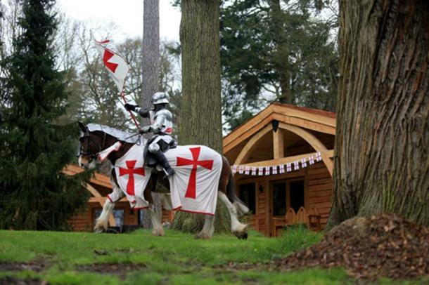 A knight on horseback passing a lodge. ((Warwick-castle.com)