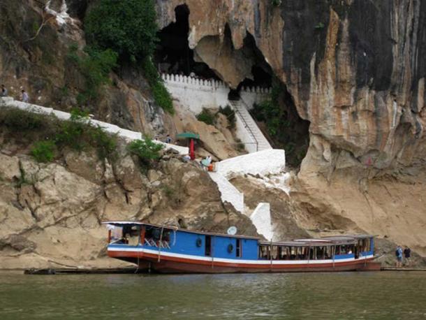 A river boat moors at the entrance to the Pak Ou Caves near Luang Prabang, Laos. Stephen Johnson/AAP