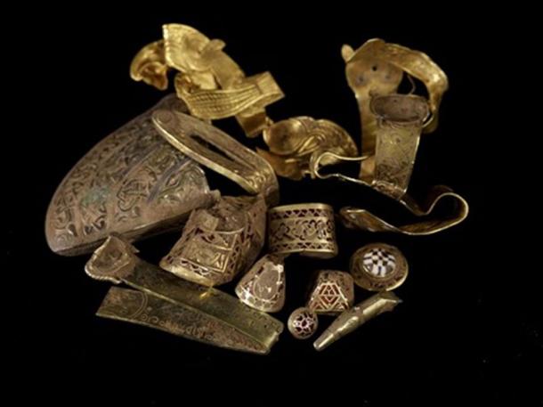 A selection of highlight pieces from the Staffordshire Hoard (top) and a gold sword hilt fitting with cloisonné garnet inlay, uncleaned by conservators, still showing traces of soil. (Staffordshire hoard / CC BY-SA 2.0)