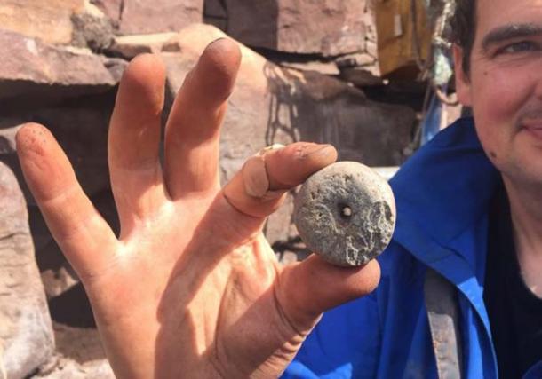 A stone whorl found in the lower rubble layer.
