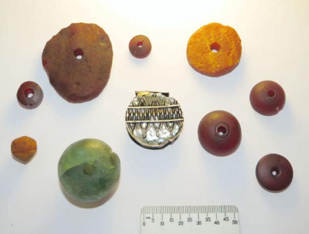 Amber and glass beads and a silver pendant from the 4-6 centuries AD found at the northern Russian burial site. (Konstantin N. Skvortsov / Institute of Archeology of the Russian Academy of Sciences)