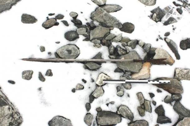 An arrow from 800 AD found on the ground in Norway, partly covered by snow. (Espen Finstad, Secrets of the Ice, Oppland County Council)