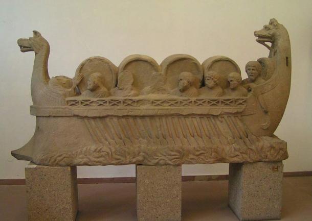 Ancient Roman river vessel carrying barrels, assumed to be wine, and people.