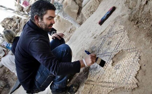 Archaeologist Kfir Arbiv of the Israel Antiquities Authority reveals a mosaic floor in the ruins of a church about three kilometers northwest of Jerusalem
