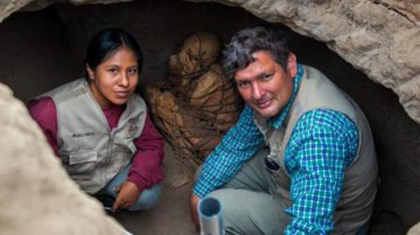 Archaeologist Pieter Van Dalen Luna, from the State University of San Marcos, Peru, on the right, with the rope-bound mummy just behind him. (UNMSM)