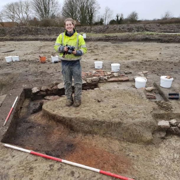Archaeologist India Jago at the excavated corn dryer which would have been used after the harvest. (DigVentures)